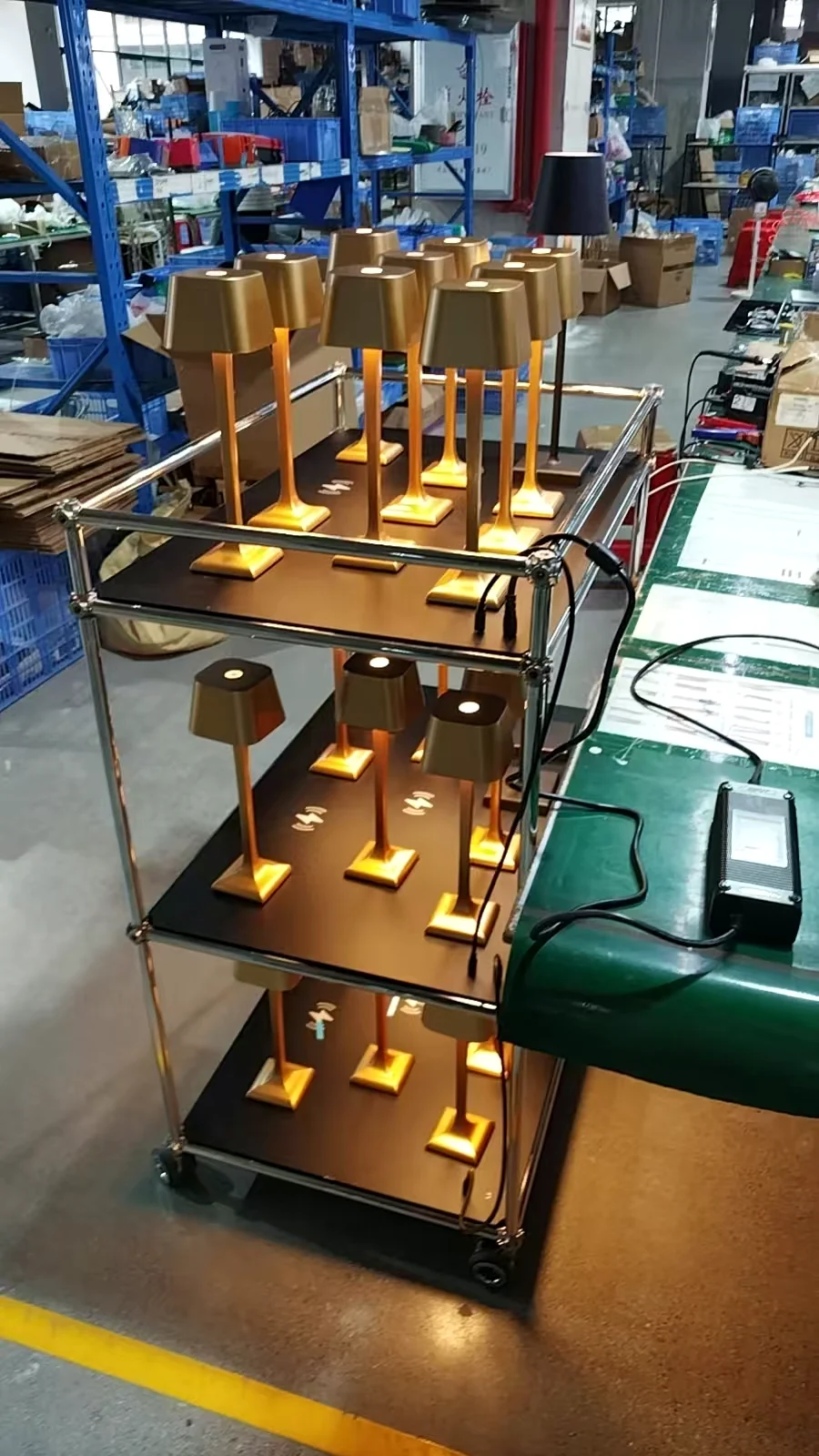 Side view of powered trolley shelves and charging adapter during testing
