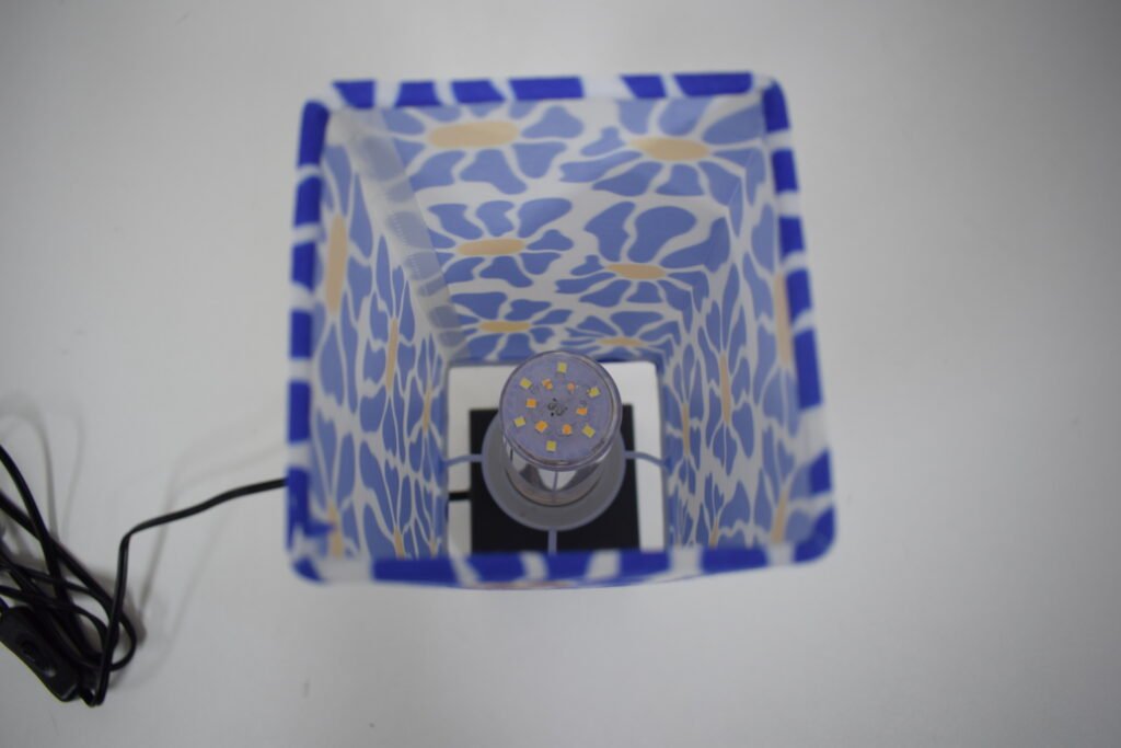 Replaceable E26 lamp holder and bulb connection detail on a fabric shade table lamp