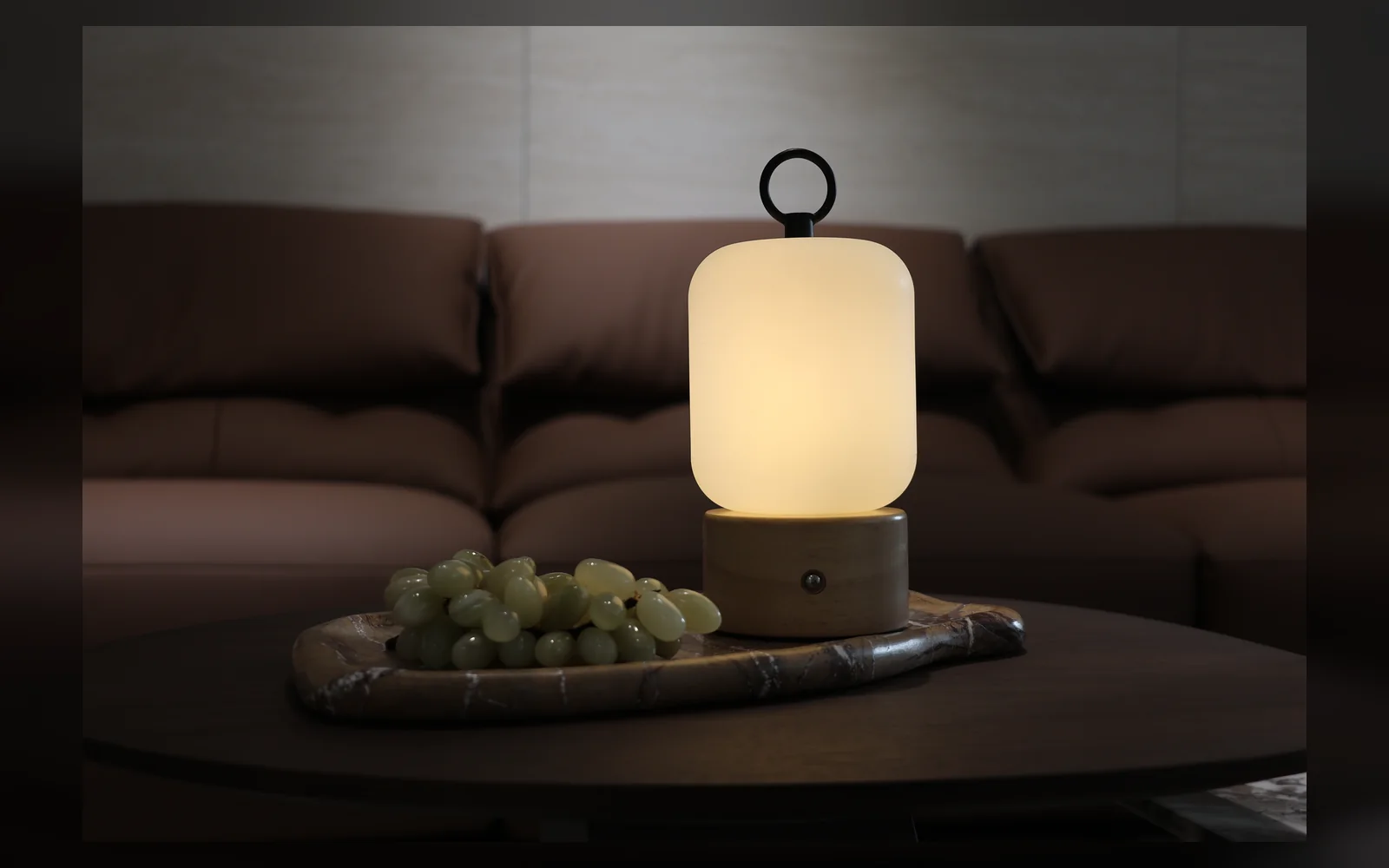 JB-468 portable bedside lamp producing warm light in a living-room setting