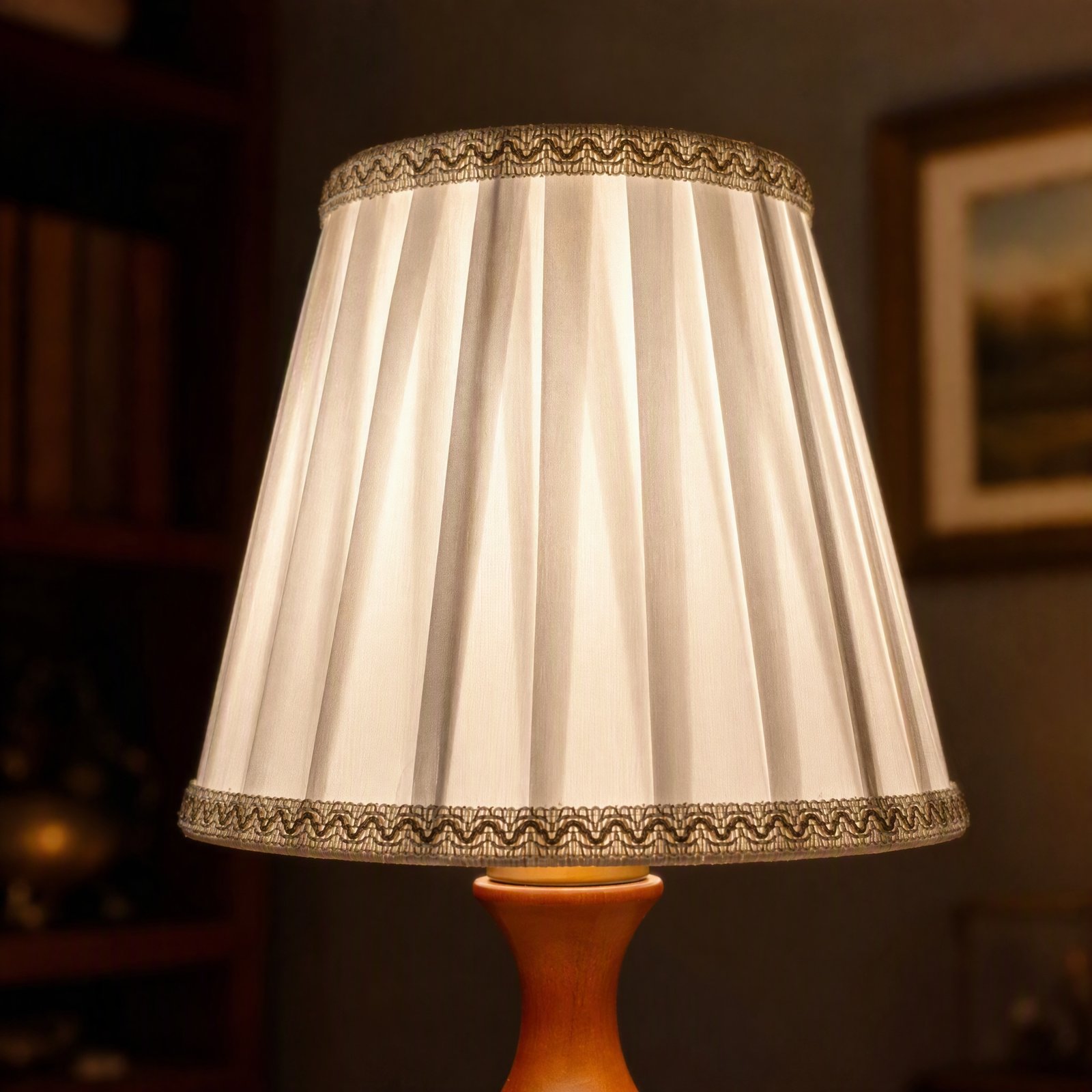 Close-up of ivory pleated fabric lampshade and decorative trim